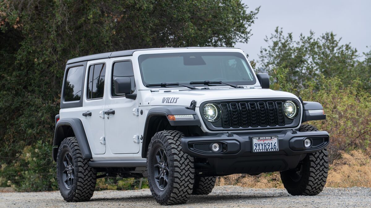 2026 Jeep Wrangler Willys front 3/4 passenger side with green foliage in the background