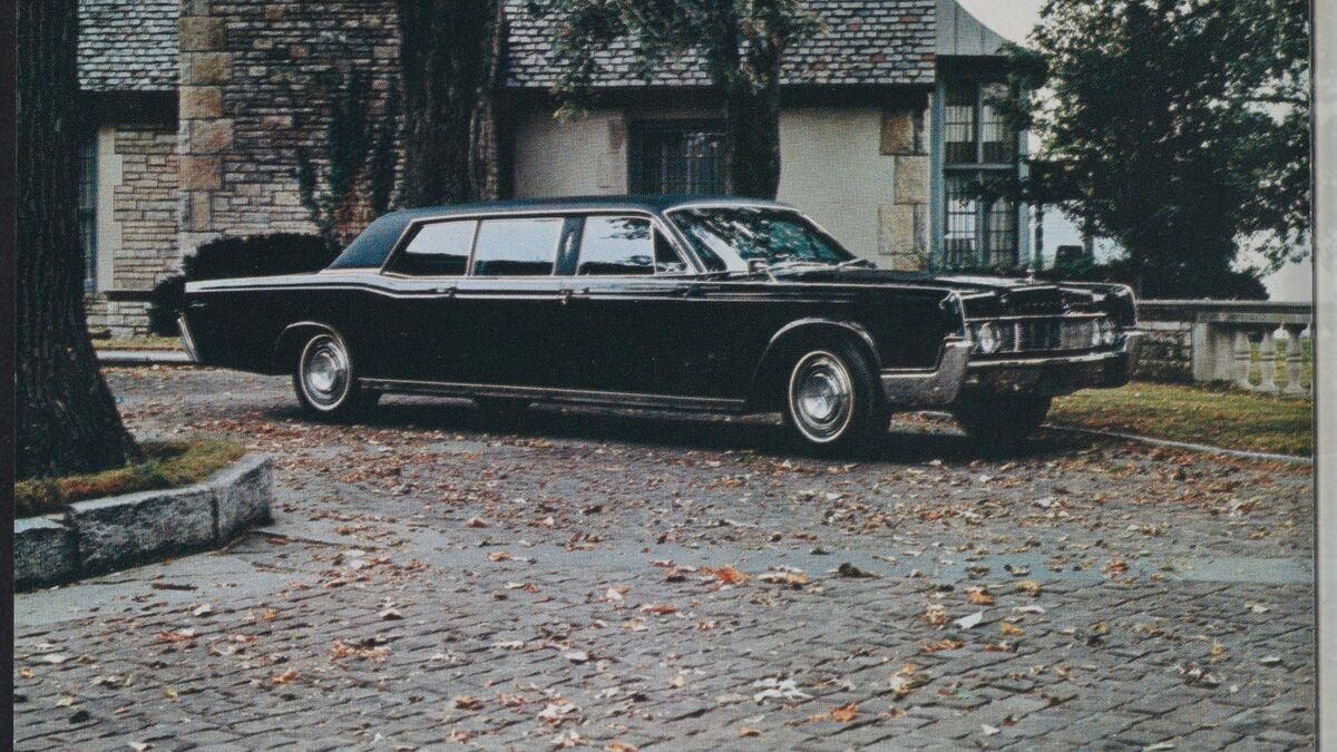 The Lincoln Continental parked in front of a house.