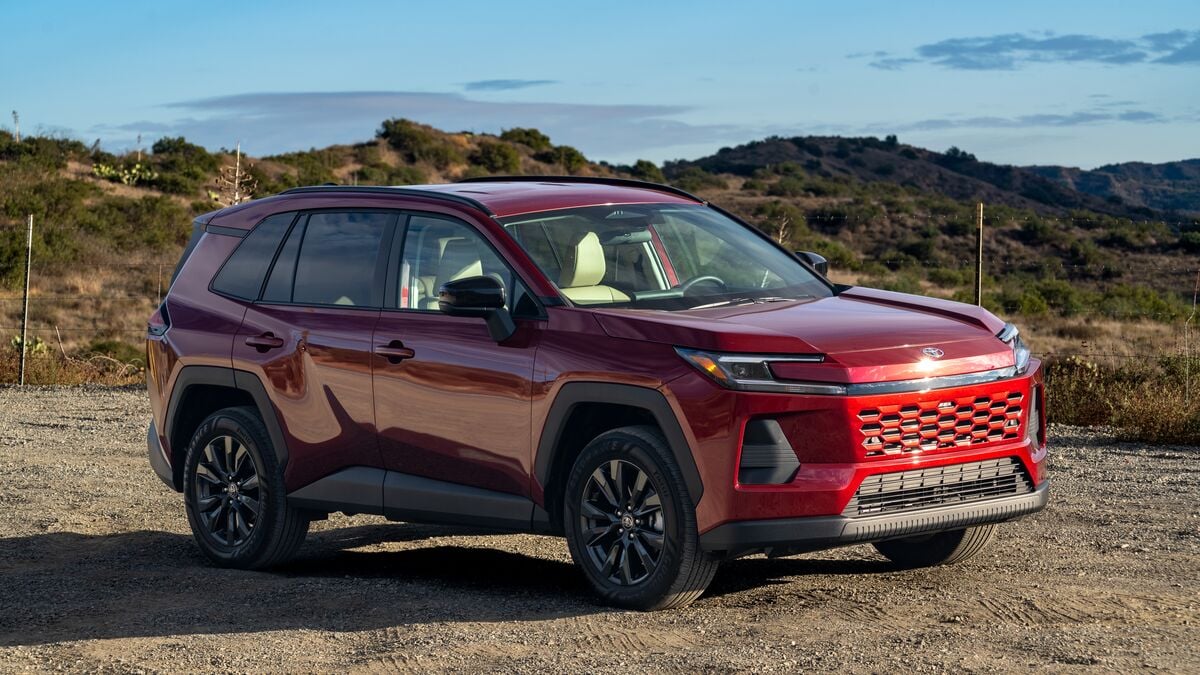 A front right 3/4 angle photo of a 2026 Toyota Rav4 XLE against a hilly backdrop under blue skies.