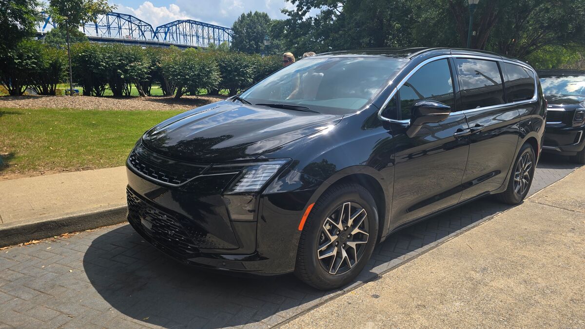 2027 Chrysler Pacifica parked on the street with a bridge in the background.