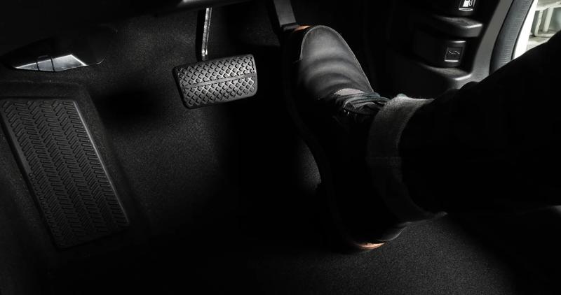 Driver pressing accelerator pedal.