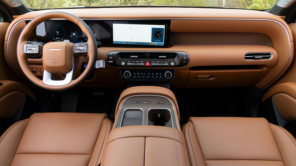 Black 2026 Hyundai Palisade Hybrid Calligraphy parked near a hillside.