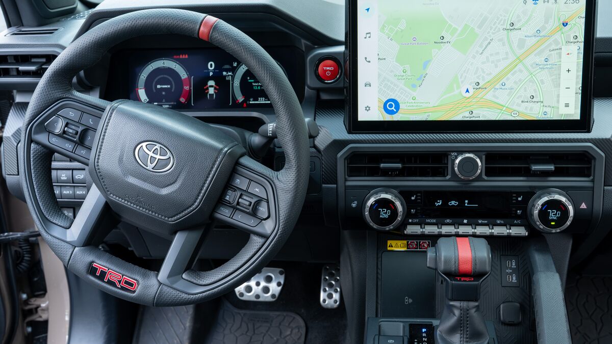 A tight detail view of the steering wheel and infotainment screen on a 2026 Toyota Tacoma TRD Pro.