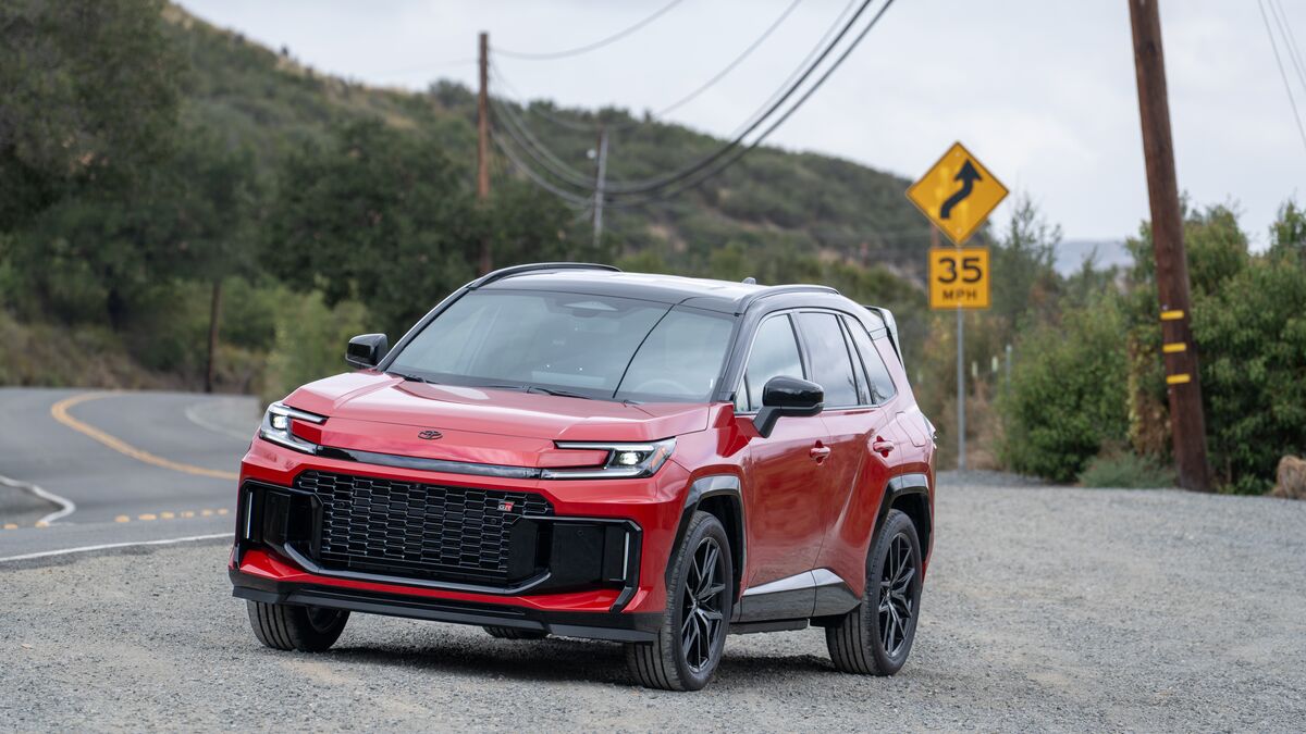 2026 Red Toyota RAV4 parked on gravel shoulder.
