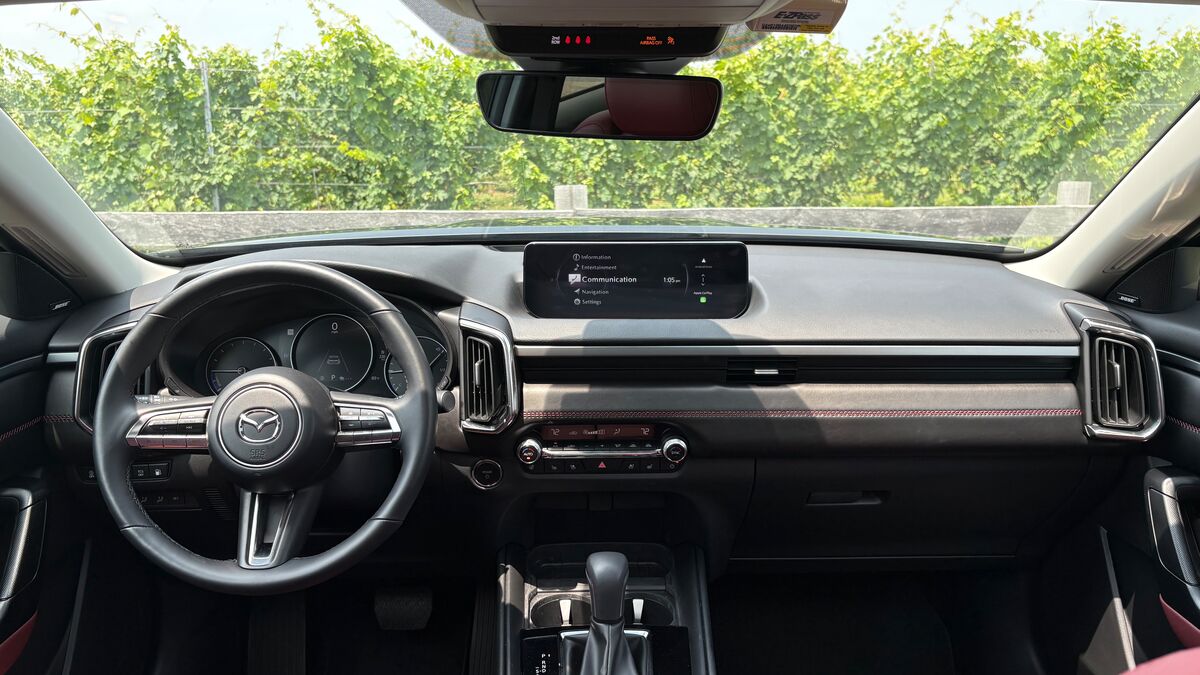2026 Mazda CX-50 Hybrid interior front dash looking out at bushes.