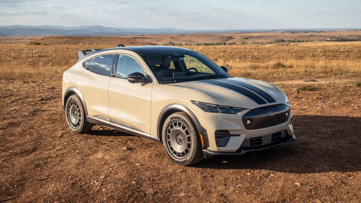 2026 Ford Mustang Mach-E Rally front 3 quarter high angle parked on dirt with mountains in the background.