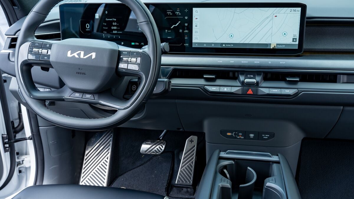 A view of the dashboard, steering wheel, and infotainment screen on the 2026 Kia EV9 GT-Line EV.
