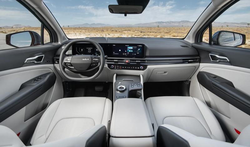 2026 Sportage hybrid interior dashboard, steering wheel, and front row seats