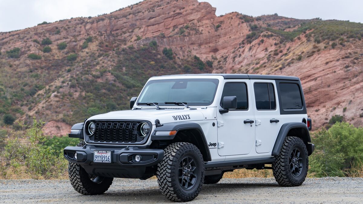 2026 Jeep Wrangler Willys front 3/4 driver side with red sandstone cliffs in the background.
