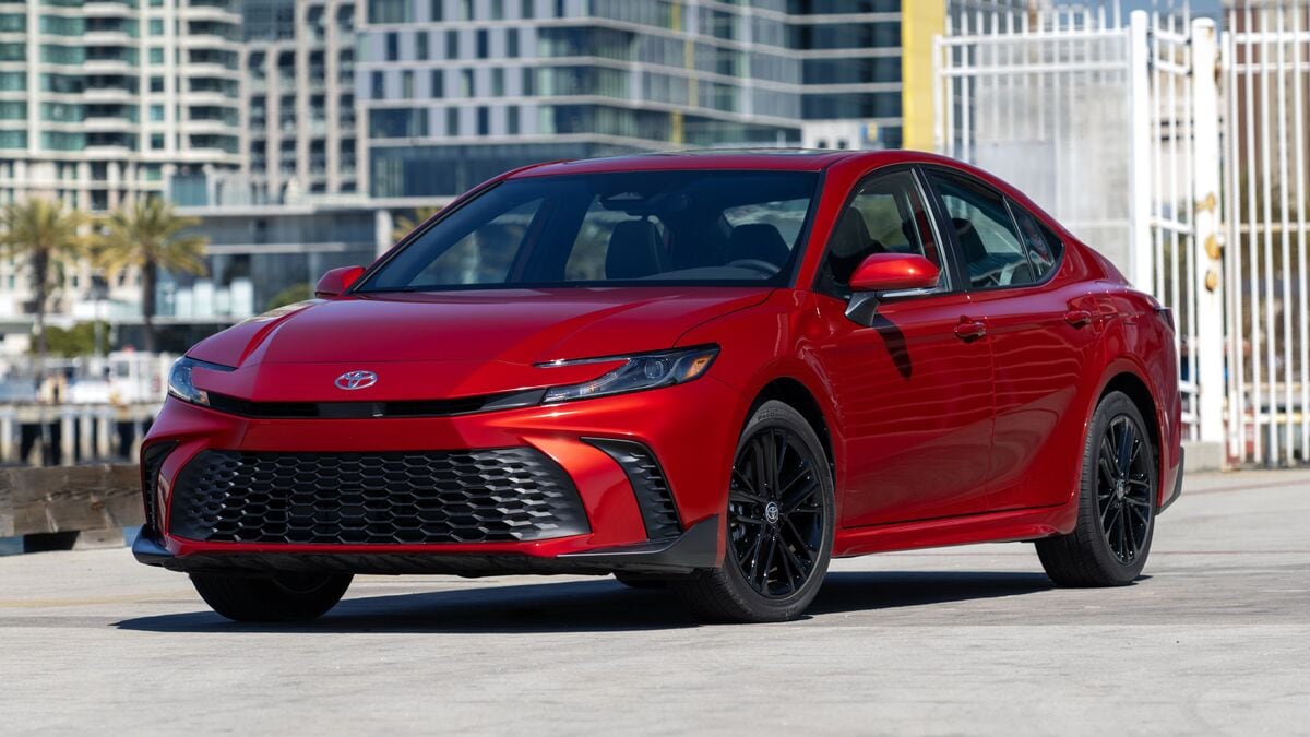 Red 2026 Toyota Camry SE AWD in city setting.