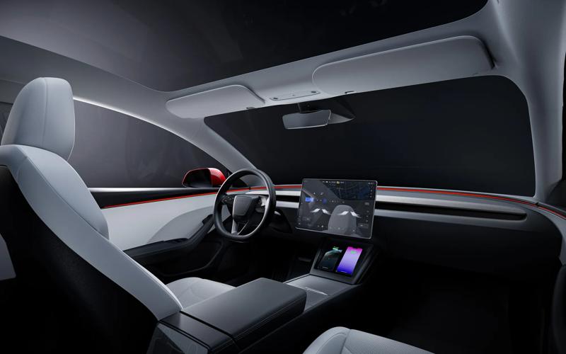 An interior view of the driver's seat, including the steering wheel and infotainment screen.