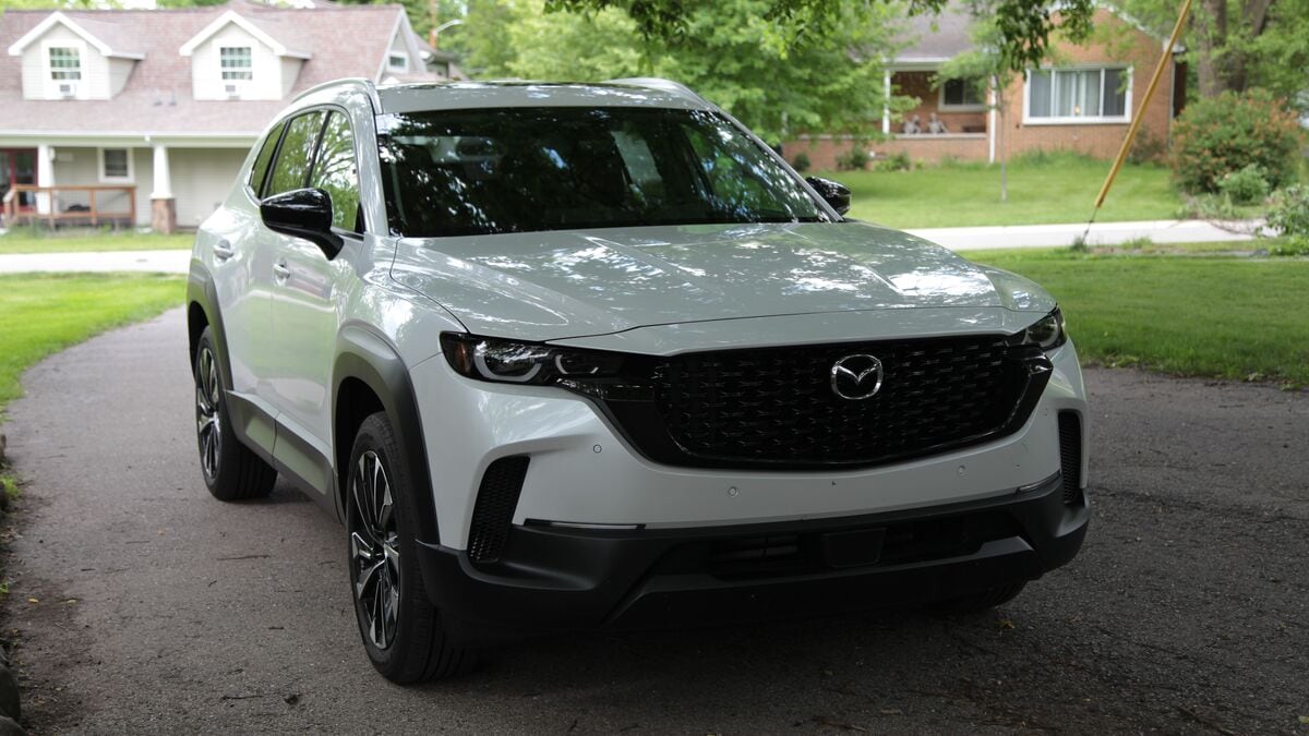 2026 Mazda CX-50 parked with houses in background.