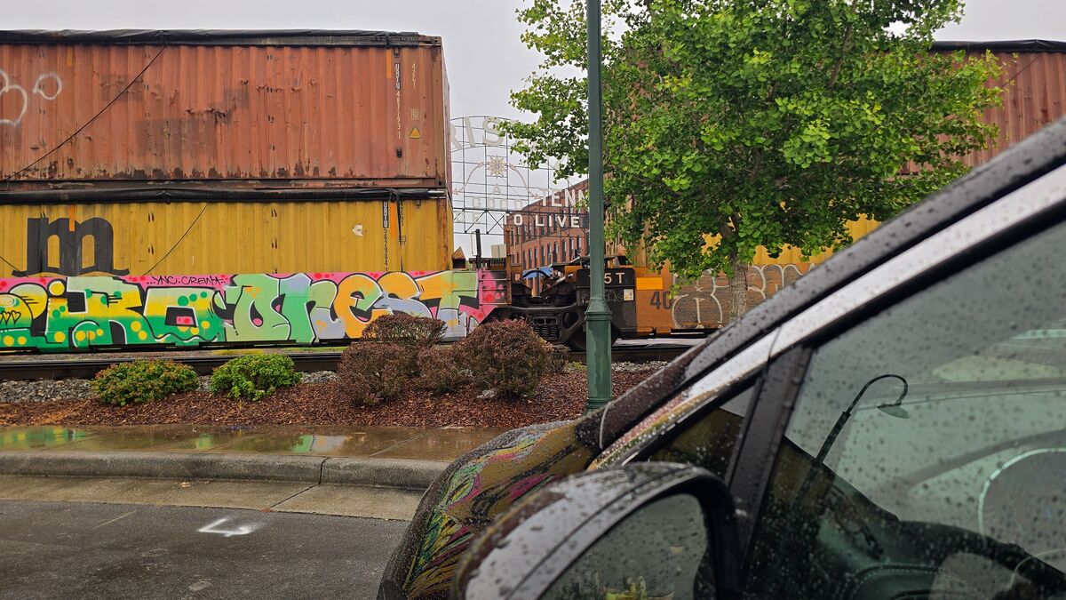 A train blocks the road to a landmark Virginia-Tennessee sign in Bristol.