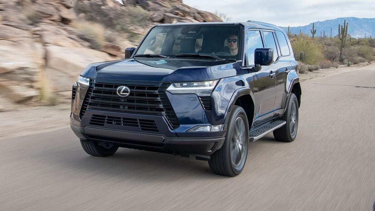 2025 Lexus GX driving on the road.