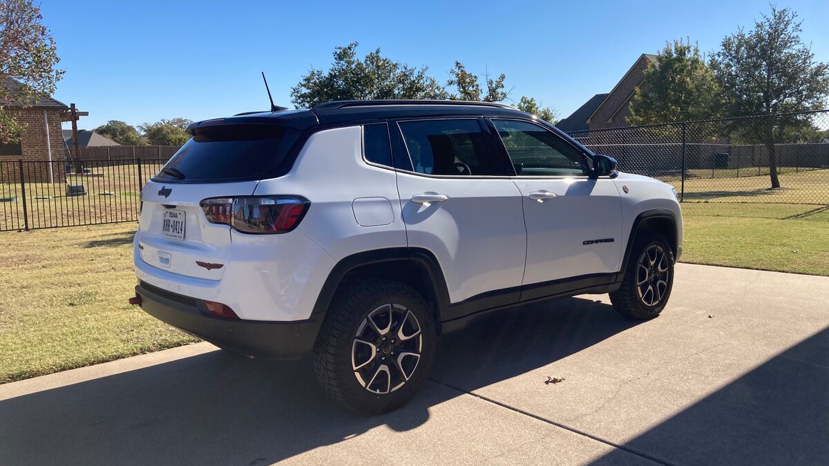 2025 Jeep Compass Trailhawk parked in driveway.
