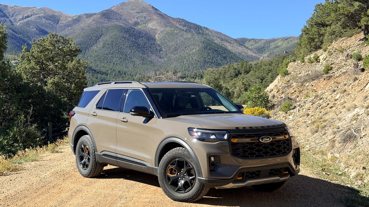 2026 Ford Explorer Tremor Edition parked on gravel by hillside.