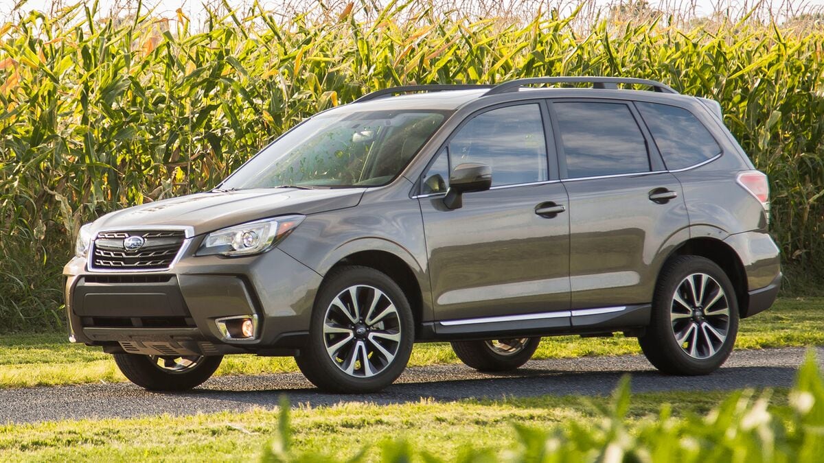 2017 Subaru Forester in green parked in a cornfield.