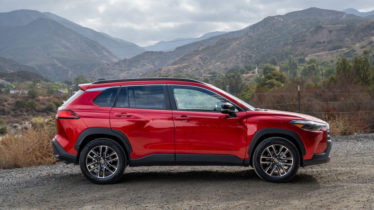2026 Toyota Corolla Cross passenger side profile against a mountainous landscape backdrop