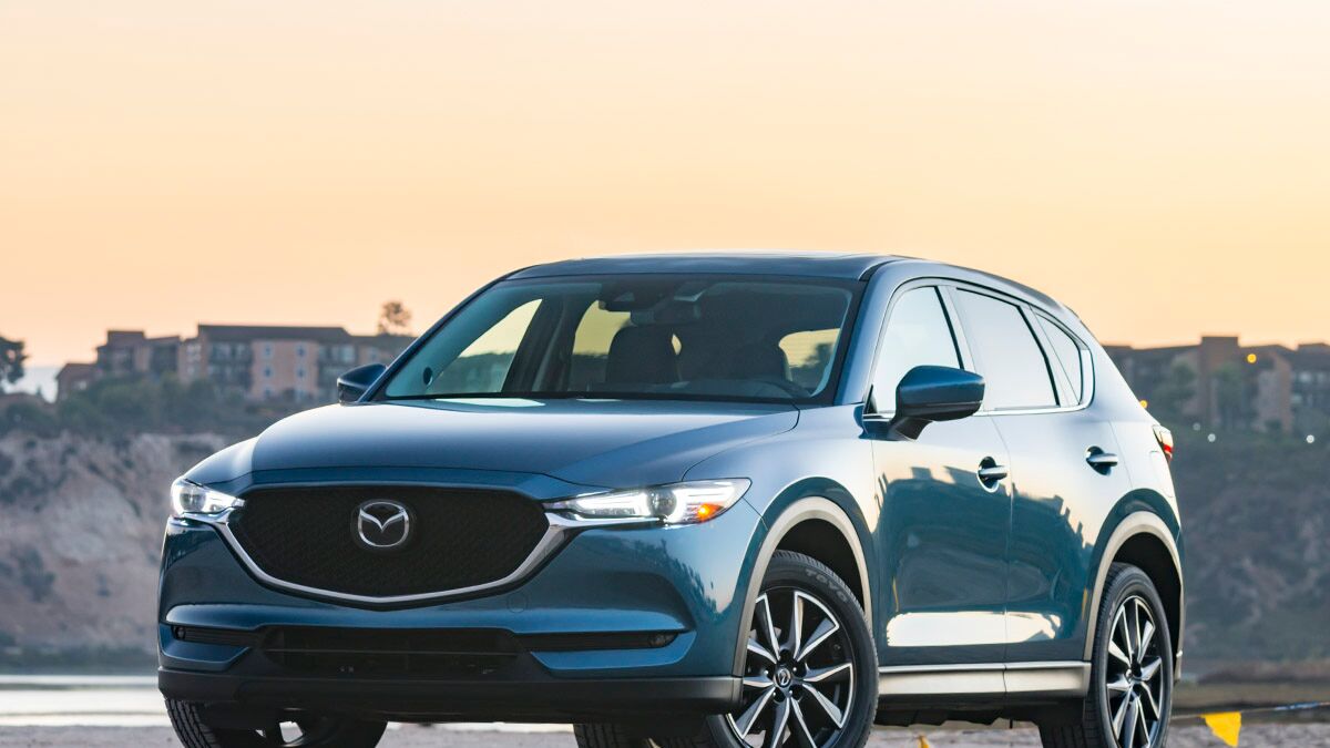 2017 Mazda CX-5 parked in the middle of the road with buildings in the background.