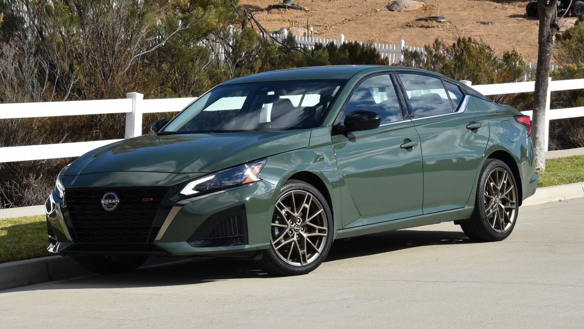 2025 Nissan Altima parked by white fence.