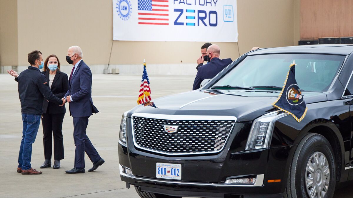 The Beast with President Biden standing next to it.