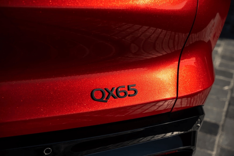 The gold-coated glass flecks in the Sunfire Red paint of the 2027 Infiniti QX65.