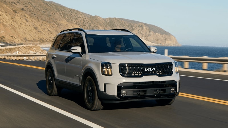 2024 Kia Telluride XPro in wolf gray driving on Hwy 1 near the Pacific.