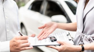 Signing a car lease agreement.