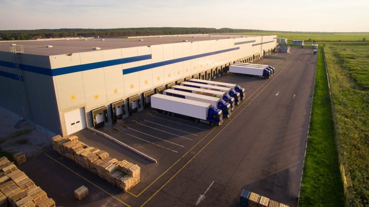 Distribution Warehouse With Trucks Of Different Capacity