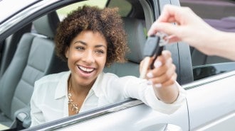 Excited Young Woman Accepts New Car Keys