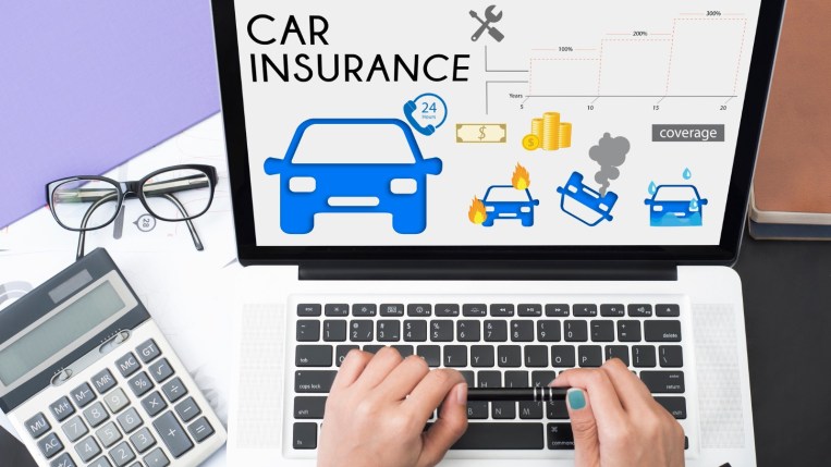 Person researching car insurance on laptop