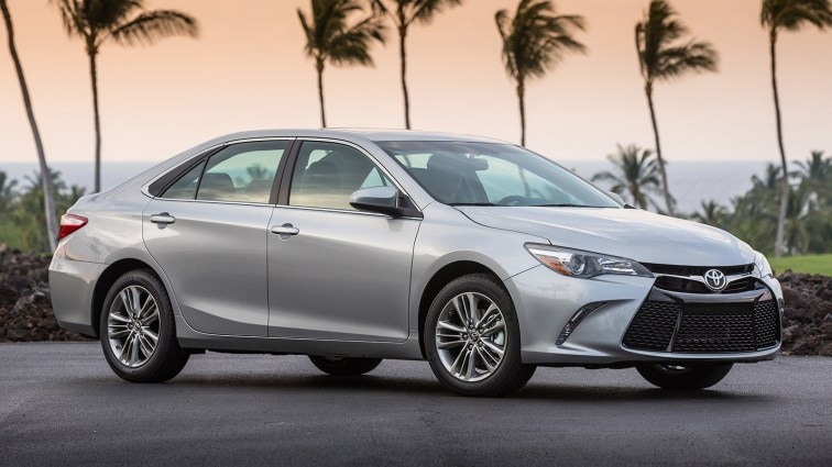 2015 Toyota Camry parked near palm trees.