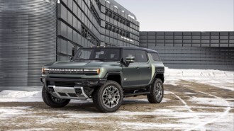 The 2023 GMC Hummer EV pickup and SUV facing each other