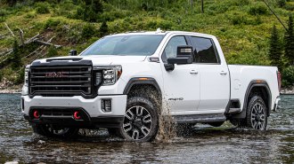 2021 GMC Sierra HD AT4 in white in a shallow river bed