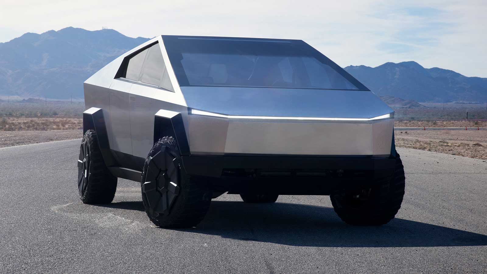 Tesla Cybertruck on the road in the desert.