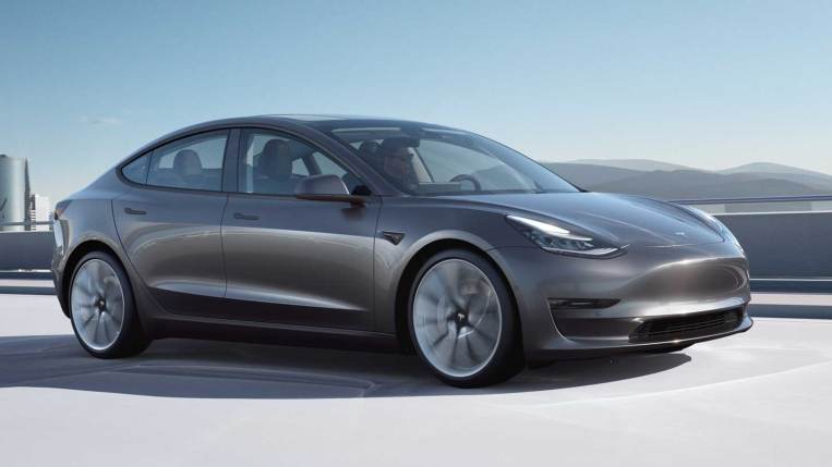 2022 Tesla Model 3 in charcoal, driving.