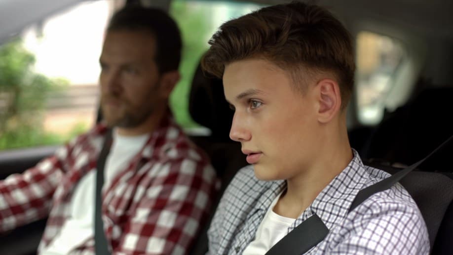 Male Instructor Teaching Teenager To Drive Automobile Safety Rules