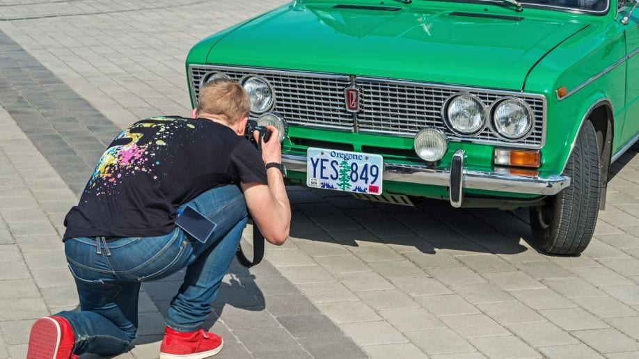 Man Photographing Car