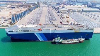A cargo ship unloading cars in a port