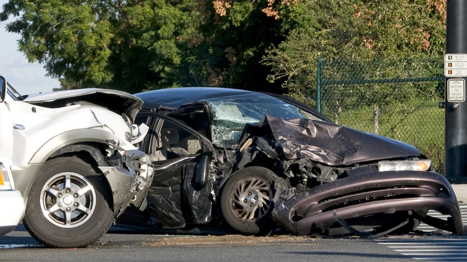 The aftermath of a crash, showing two mangled cars