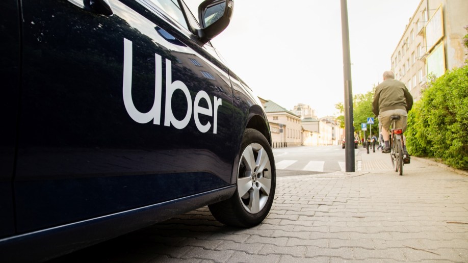 A black car with the Uber logo on the door