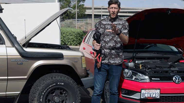 Two vehicles in position to jump-start a dead car battery.
