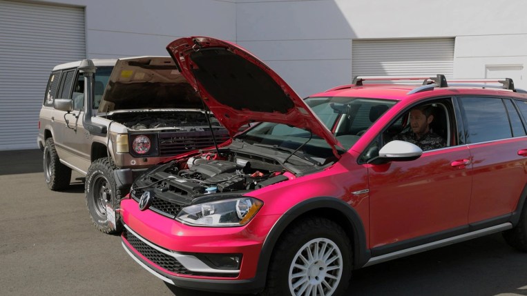 A person jump-starting a car with a dead battery after attaching jumper cables.