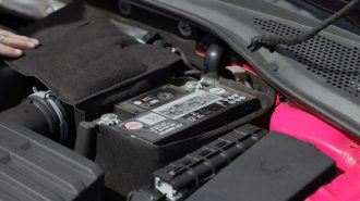 A car battery in the engine bay.