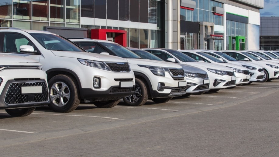 A line of cars at a dealership