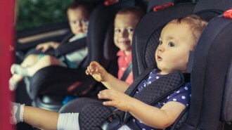 Three Children In Car Safety Seat