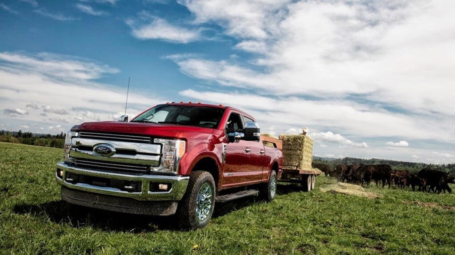 2018 Ford F-250 Lariat in red on a farm.