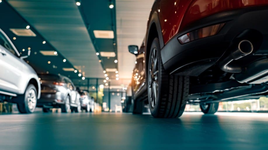 A low-angle photo of cars inside a dealership