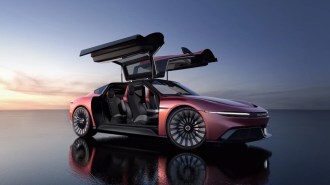 The DeLorean Alpha5 in red with its gullwing doors open
