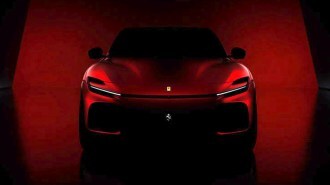 The 2023 Ferrari Purosangue from a head-on view, smiling because it plans to eat you.